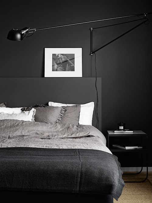 I'm loving this dark bedroom with the Serge Mouille look-a-like wall lamp and stone-gray linen on the bed - via Anna Gillar