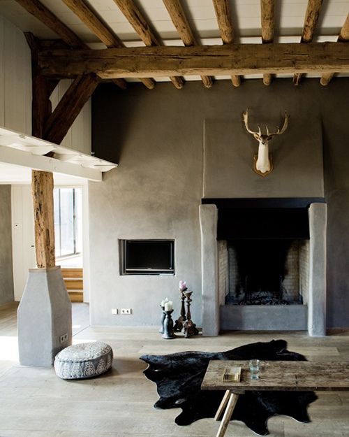 A little deer over the fireplace and look at how clever the TV has been recessed into the wall - via The Decorista