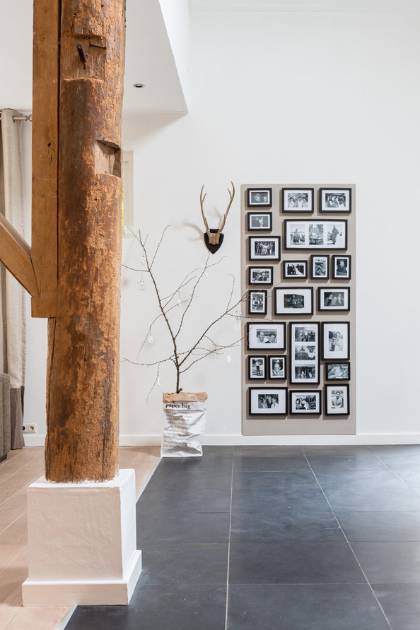 Black and white gallery wall in a Dutch house, photographed by Hans Mossel