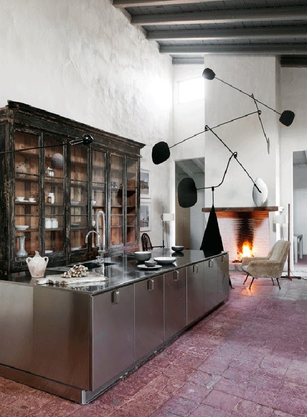 I love the contrast of the antique cupboard, the industrial steel island and the light fixture by Design Icon Serge Mouille - via Belle Vivir