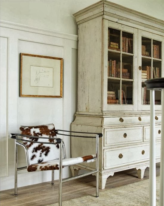 The iconic Wassily chair by Marcel Breuer next to an antique armoire - via Dustjacket