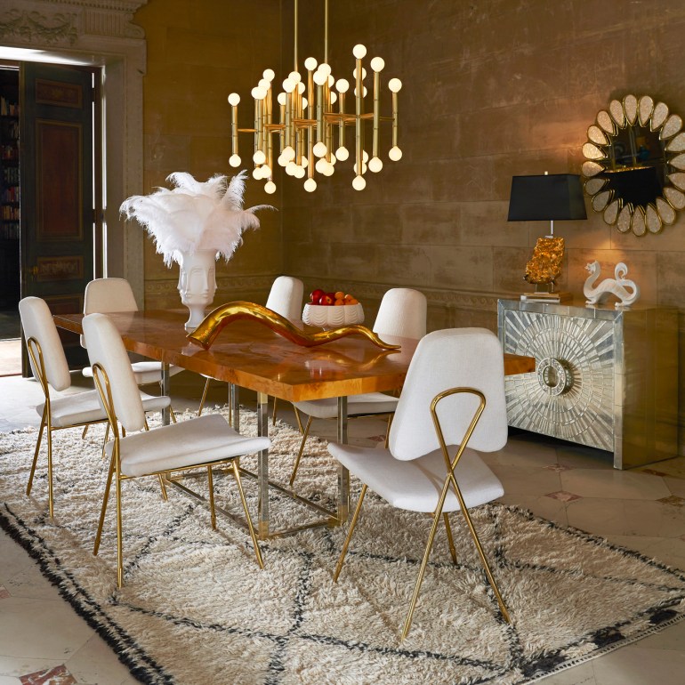 Enchanting Adler-designed diningroom with the minimalist and sculptural brass Maxime Dining Chairs and the Meurice Chandelier