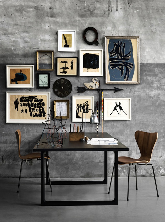 Bare concrete walls as a base for this gallery wall of contemporary art, which combine perfectly with the Mid Century Series 7 chiars by Arne Jacobson - via Inthralld