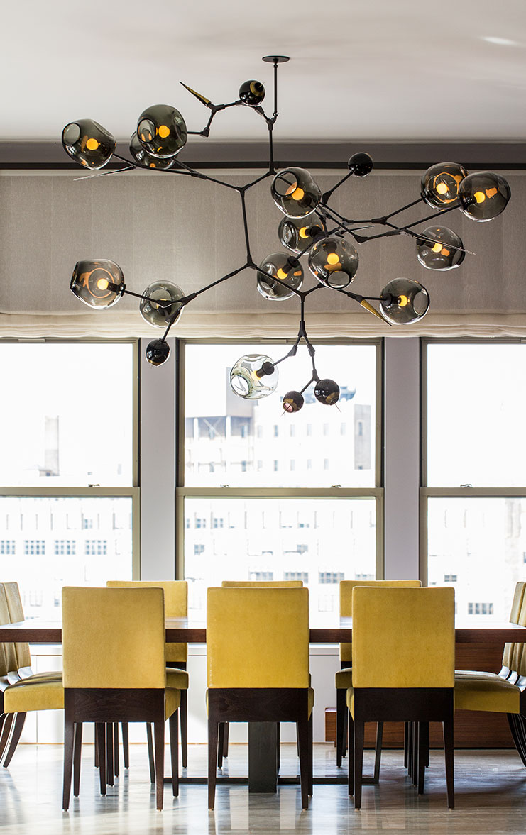 Yellow dining chairs and a huge Branching Bubbles chandelier by Lindsay Adelman