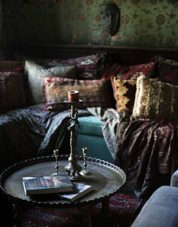 Antique Arabian coffeetable with lots of throwpillows on the sofa - via David Prince Photography