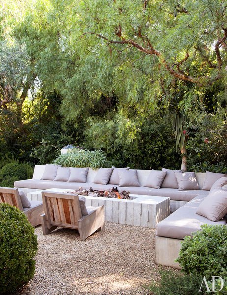 Concrete outdoor firepit in actor Patrick Dempsey's Malibu home - via Architectural Digest