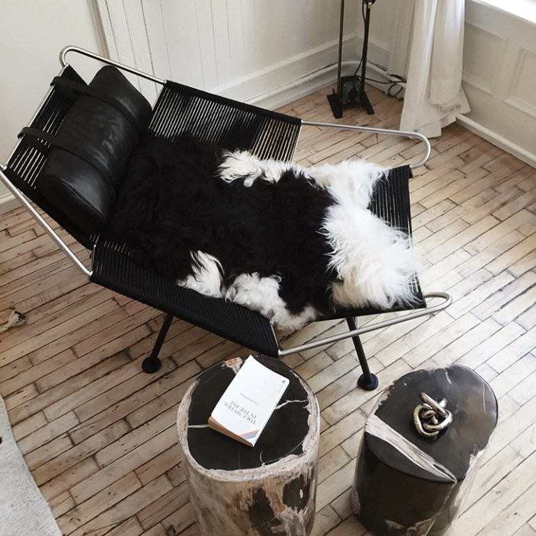 A sheepskin from Iceland in a vintage Hans Wegner chair in NY appartment shop The Line - via Fashion Squad