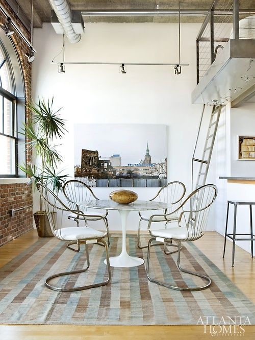 Tulip table in a loft via The Bower Birds