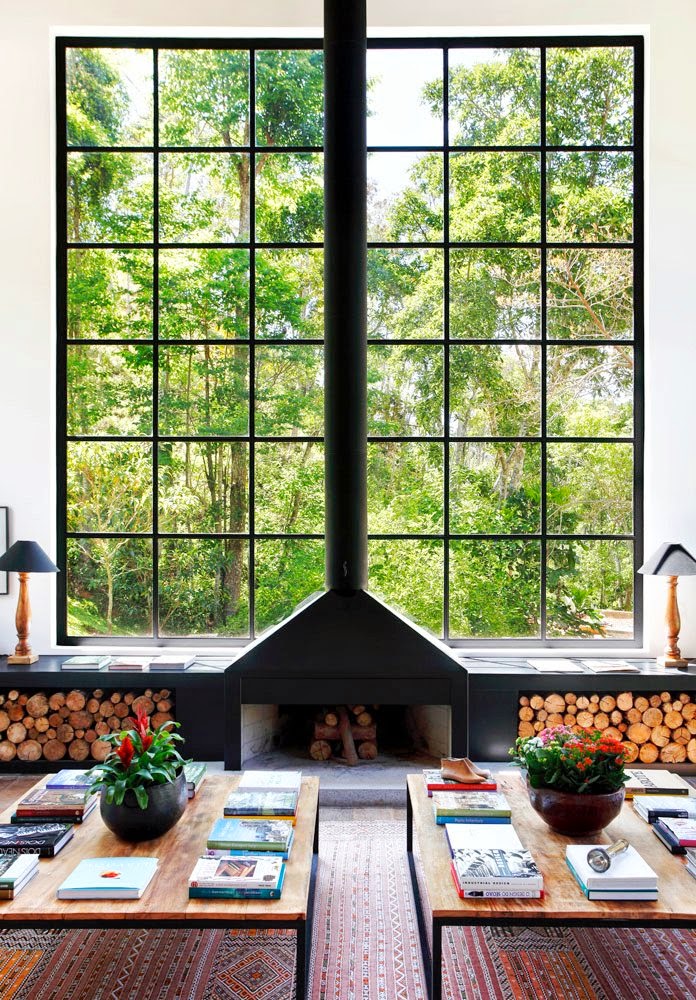 I love the unique combination of the black steel of the windowframe and fireplace