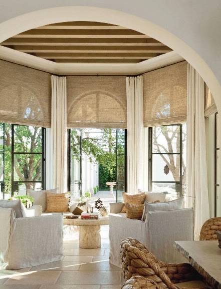 I love the contrast of the black steel and the ton-sur-ton interior in this tropical conservatory - via Design Chic