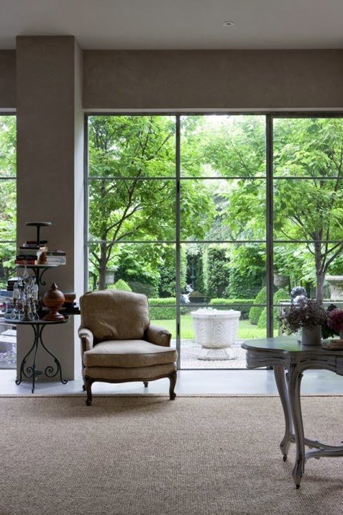 What a great way to let in the view, wonderful combination of modern architecture combined with elegant antiques