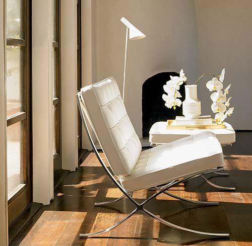 Lovely white Barcelona chair with a Louis Poulsen lamp at its side