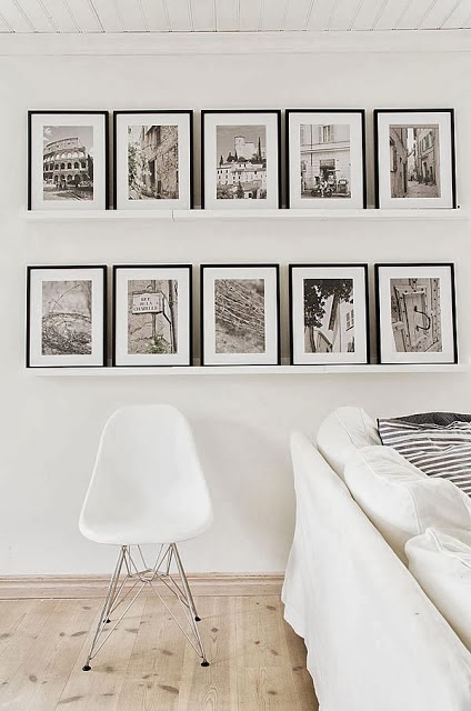 Black & white interiors theme extended into the pictures and frames - via Cococozy