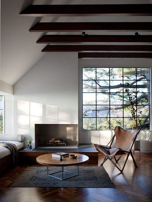 I love this room, panorama window, double volume ceiling, daybed for daydreaming, fireplace and of course a butterfly - via Apartment Therapy