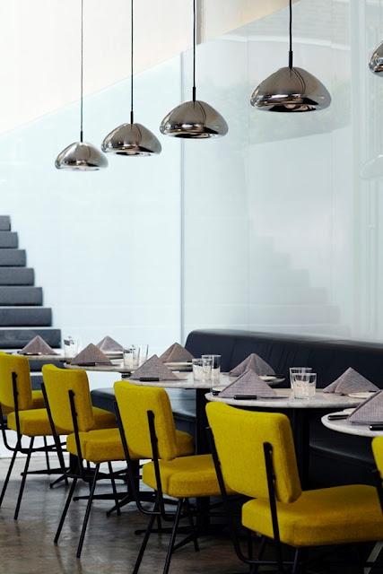 New York Hotel Americano's dining room with mustard chairs, by French designer Arnaud Montigny - via Mariana Vieira