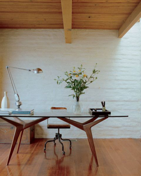 Vintage glass-top table used as a desk by Californian interior designer Michael S. Smith - via Elle Decor